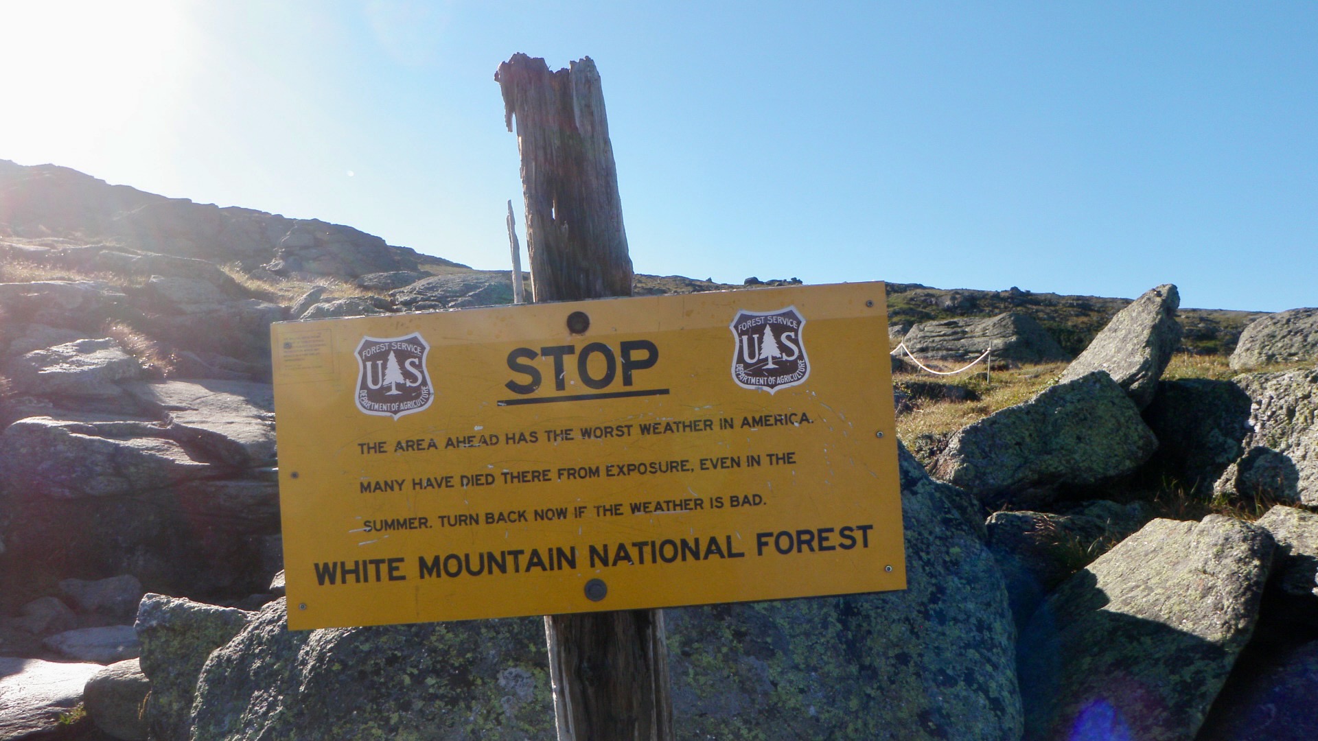 Yellow sign warning that 'THE AREA AHEAD HAS THE WORST WEATHER IN AMERICA.'
